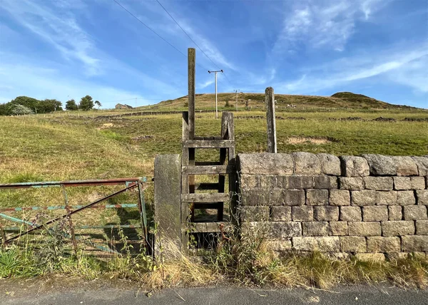 stock image View over a wooden stile, summers evening near, Huddersfield Road, Denshaw, UK