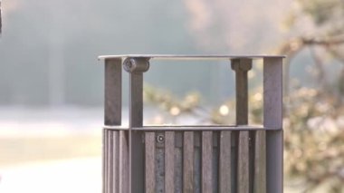Woman throwing away waste in the trash bin or dumpster, ecological concept