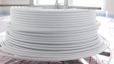 Installing underfloor heating white pipes for water heating, heating systems, white pipes for heat insulated floor, industrial concept