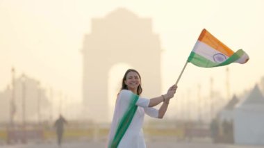 Happy Indian Republic day celebration at India gate Delhi, Proud Indian woman hoisting the Indian flag