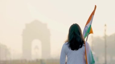 Confident Indian girl giving respect to soldiers at India gate Delhi