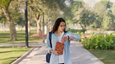 Indian girl running late to her class, moving fast in ground