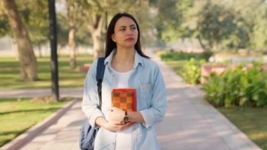 New college student going to university for the first time with notebooks and backpack