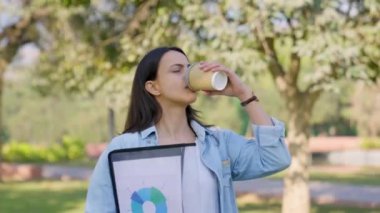 Confident Indian boss going for work through a park in a morning while sipping coffee