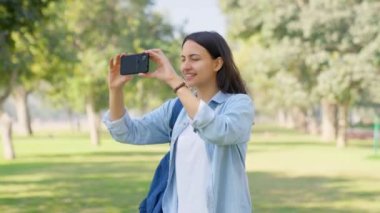Indian girl shooting videos for her social media using mobile phone