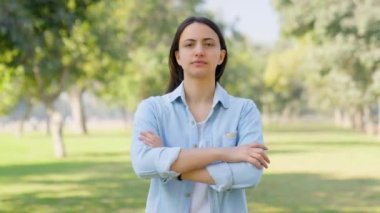 Confident Indian girl standing crossed hands