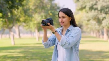 Indian photographer clicking photos of nature using expensive camera