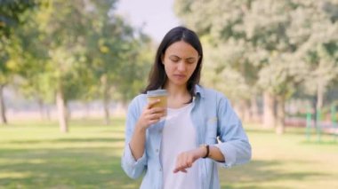 Curious Indian girl waiting for her friends in a park in daylight