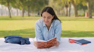 Indian girl doing a solo picnic in a park in daylight