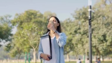 Indian business corporate woman going for work through a park in a daylight