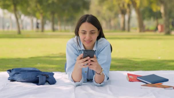 Indian Girl Using Her Mobile Phone Park — Stockvideo