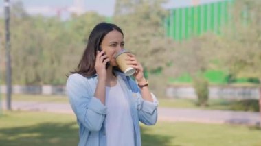 Indian boss talking on a phone while walking in a park