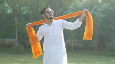Indian man dancing at a Holi party in an traditional attire
