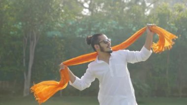Indian man doing Bollywood dance at a park