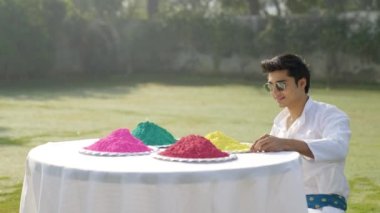 Indian man looking at Gulal holi colors