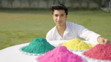 Indian man with Holi colors looking at the camera