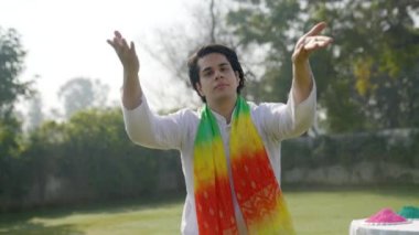 Drunk Indian man dancing in a park in traditional outfit