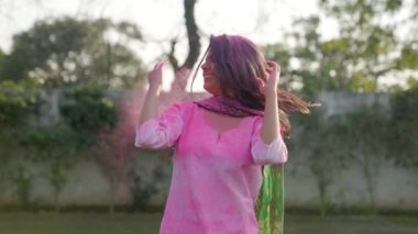 Indian woman enjoying at a Holi party