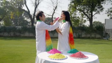 Beautiful Indian couple celebrating Holi festival