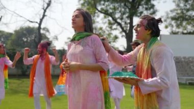 Indian man surprising his wife with Holi colors