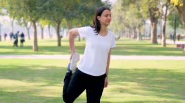 Indian girl doing leg stretching for her run in a park in morning