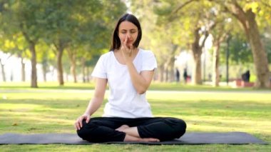 Indian yoga girl doing Pranayam and yoga and meditation in a park in morning