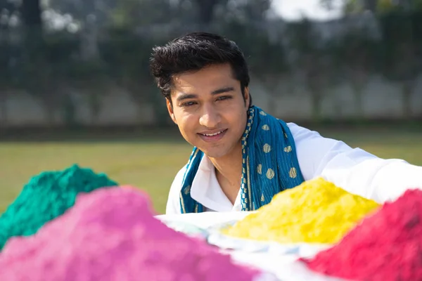 Indian man looking at Gulal holi colors