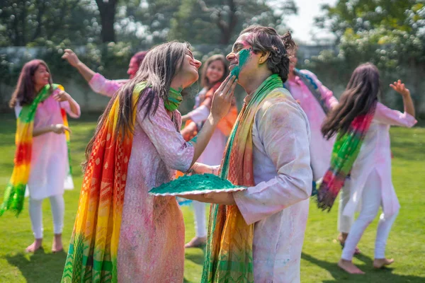 Cute Indian couple enjoying Holi festival
