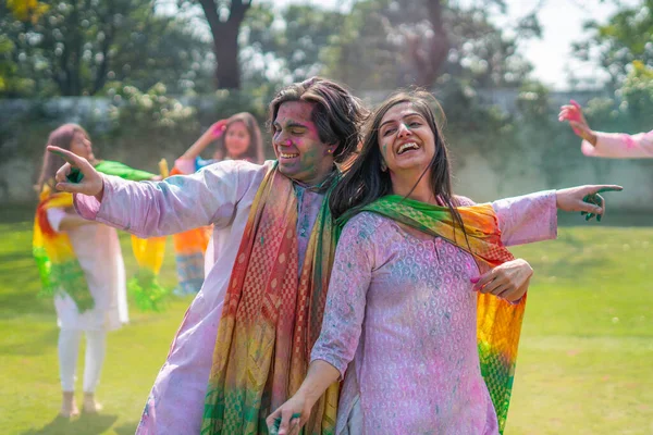 Indian couple dancing in a Holi festival