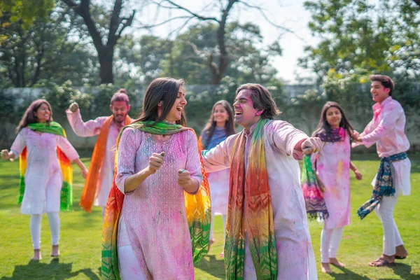 Indian couple dancing at a Holi party