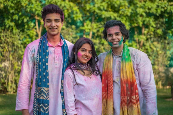 Indian friends in tradition wear outfit in a Holi festival