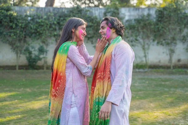 Romantic Indian couple celebrating Holi festival