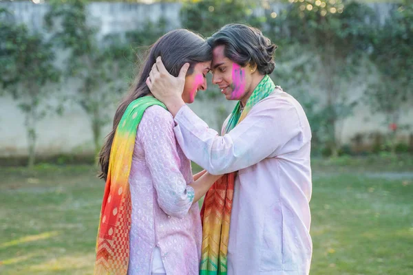 Cute Indian couple enjoying Holi party