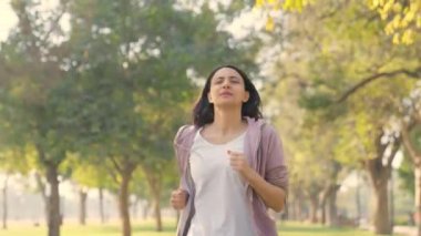 Indian woman running and exercising in a park in morning time