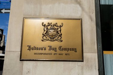 Toronto, Canada - November 9, 2020: An old Hudson Bay Company metal sign on the wall outside the flagship store is seen in Toronto. The Hudson's Bay Company is a Canadian retail business group. clipart