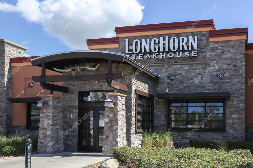 Orlando, FL, USA - February 16, 2022: Close up of LongHorn Steakhouse restaurant sign on the building. LongHorn Steakhouse is an American casual dining restaurant chain.