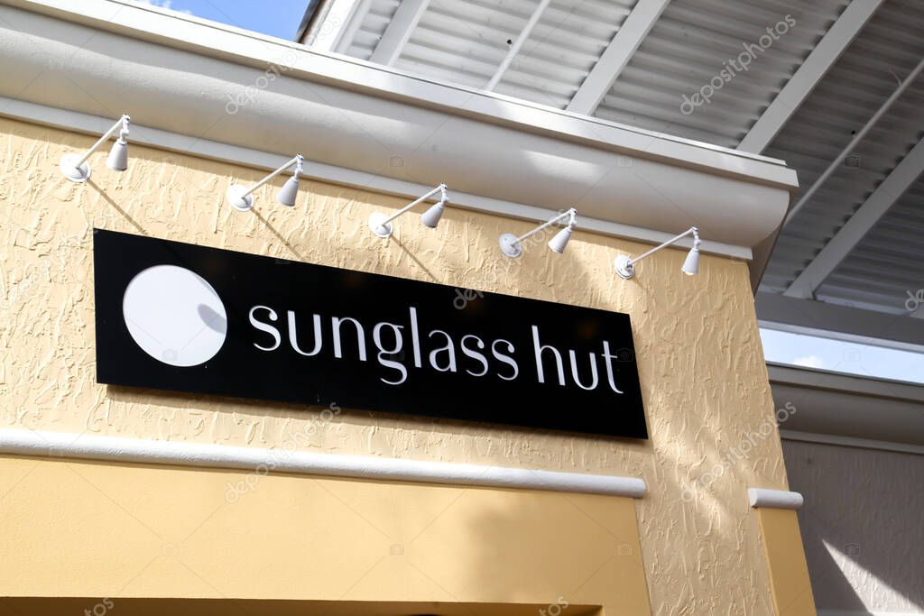 Orlando, Florida, USA - February 24, 2020: Sunglass Hut store hanging sign outside of the store in Orlando, Florida, USA. Sunglass Hut is a retailer of sunglasses and sunglass accessories.