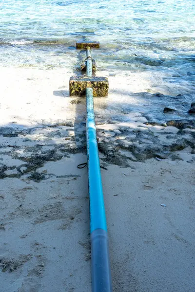 A blue sewage pipe from an island to Indian Ocean in Maldives.