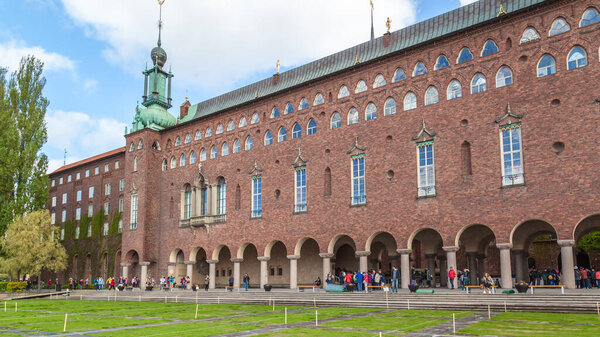 STOCKHOLM, SWEDEN - MAY 21, 2016: Tourists visit Stockholm City Hall. The Stockholm City Hall is the venue of the Nobel Prize banquet held on 10th of December each year.