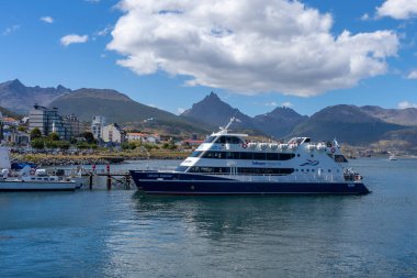 A Tolkeyen Patagonia Cruise ship at Port of Ushuaia, Tierra del Fuego province, Argentina - January 28, 2023. Tolkeyen Patagonia is a Travel and Tourism company. clipart