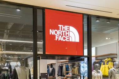 Houston, Texas, USA - February 25, 2022: North Face store closeup sign in a shopping mall. The North Face is an American outdoor recreation products company. clipart