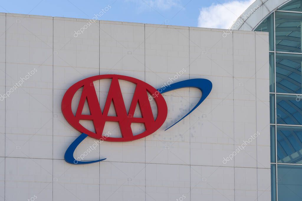 Heathrow, FL, USA - January 17, 2022: Close up of AAA sign on the building at their headquarters in Heathrow, FL, USA. AAA (American Automobile Association) is a federation of motor clubs.