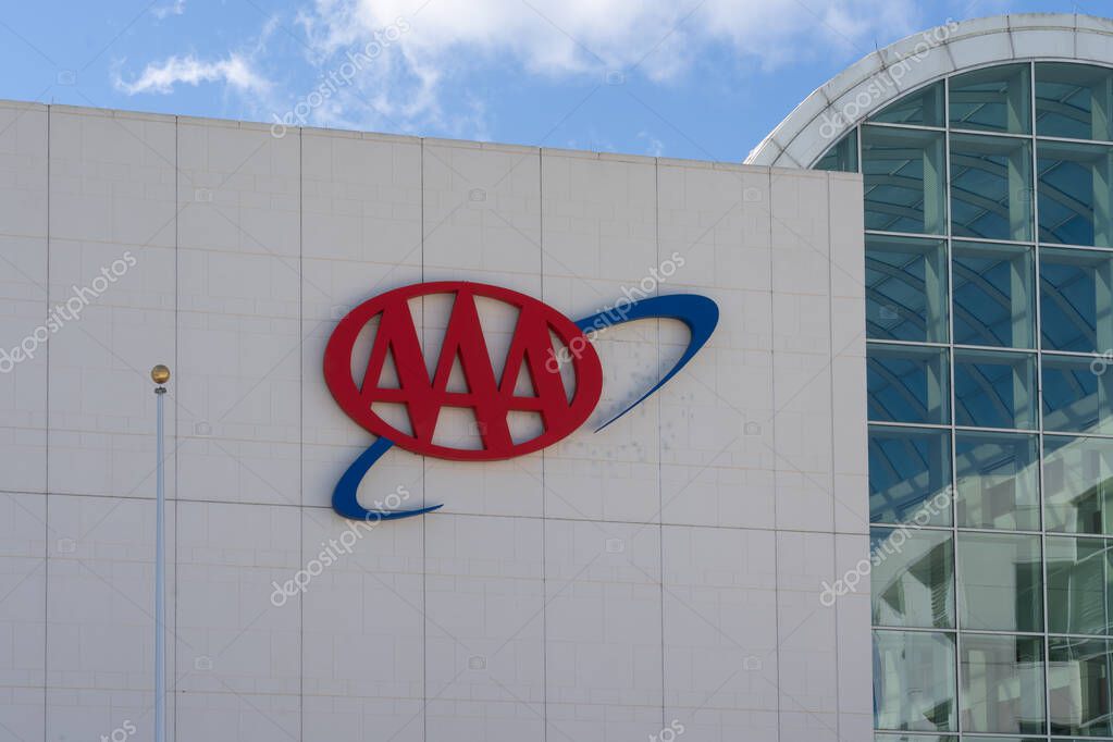 Heathrow, FL, USA - January 17, 2022: Close up of AAA sign on the building at their headquarters in Heathrow, FL, USA. AAA (American Automobile Association) is a federation of motor clubs.