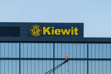 Omaha, NE, USA - May 6, 2023: Kiewit sign on its headquarters building in Omaha, NE, USA. Kiewit Corporation is an American privately held construction company. clipart