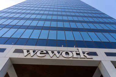 Close up of WeWork sign on an office building in Salt Lake City, Utah, USA - May 11, 2023. WeWork Inc. is an American provider of coworking spaces, including physical and virtual shared spaces.