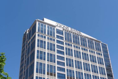 Close up of Zions bank sign on the building at its headquarters in Salt Lake City, Utah, USA - May 12, 2023. Zions Bank corporation is a bank holding company.