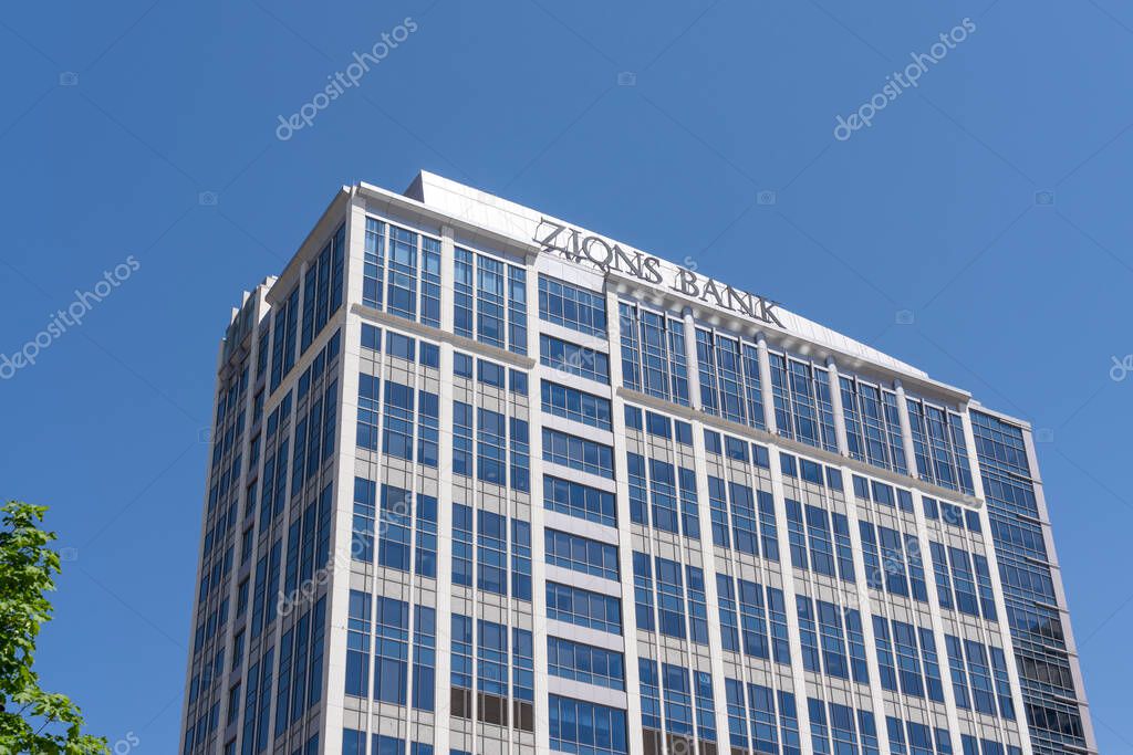 Close up of Zions bank sign on the building at its headquarters in Salt Lake City, Utah, USA - May 12, 2023. Zions Bank corporation is a bank holding company.