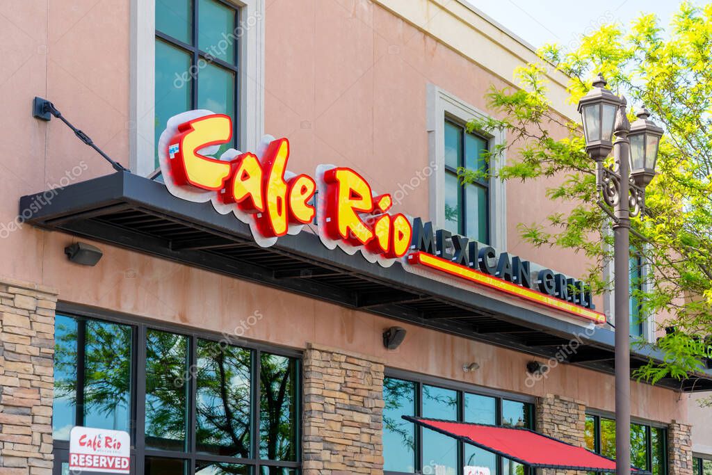 A Cafe Rio sign on the building is shown. Salt Lake City, Utah, USA - May 15, 2023. Cafe Rio, or Cafe Rio Mexican Grill, is an American fast casual restaurant chain.