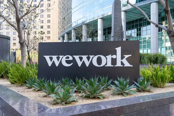 stock image Close up of the WEWORK sign outside an office building at Broadway, Oakland, California, United States - June 5, 2023. WeWork Inc. is a provider of coworking spaces.