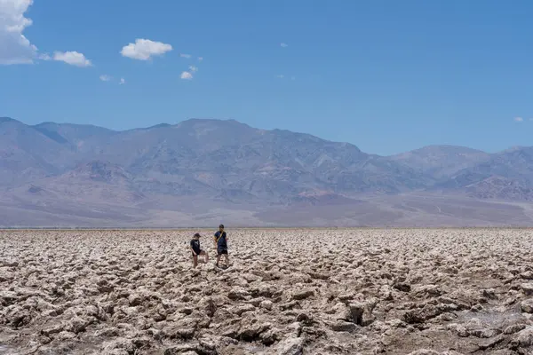 stock image Unrecognized People visiting Badwater Basin in Death Valley NP, California, USA - June 1, 2023. Badwater Basin is an endorheic basin, the lowest point in North America.